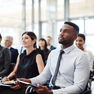 Shot of a group of businesspeople attending a conference